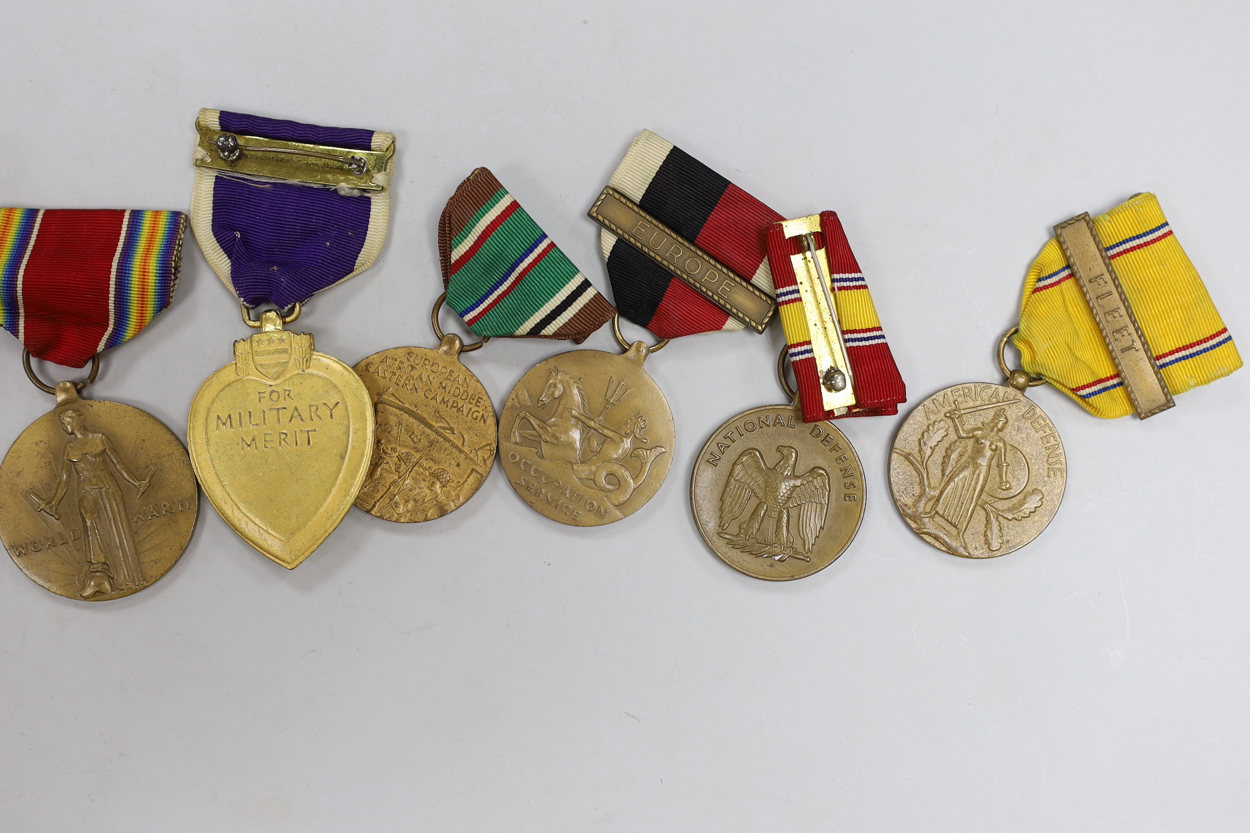 A collection of American WWII medals, including a Purple Heart, unnamed